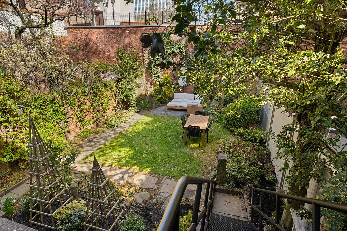 rear yard with planting beds, lawn, paved patio