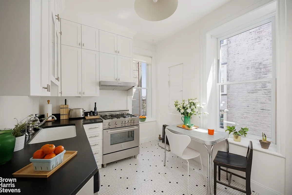 kitchen with white cabinets, white walls