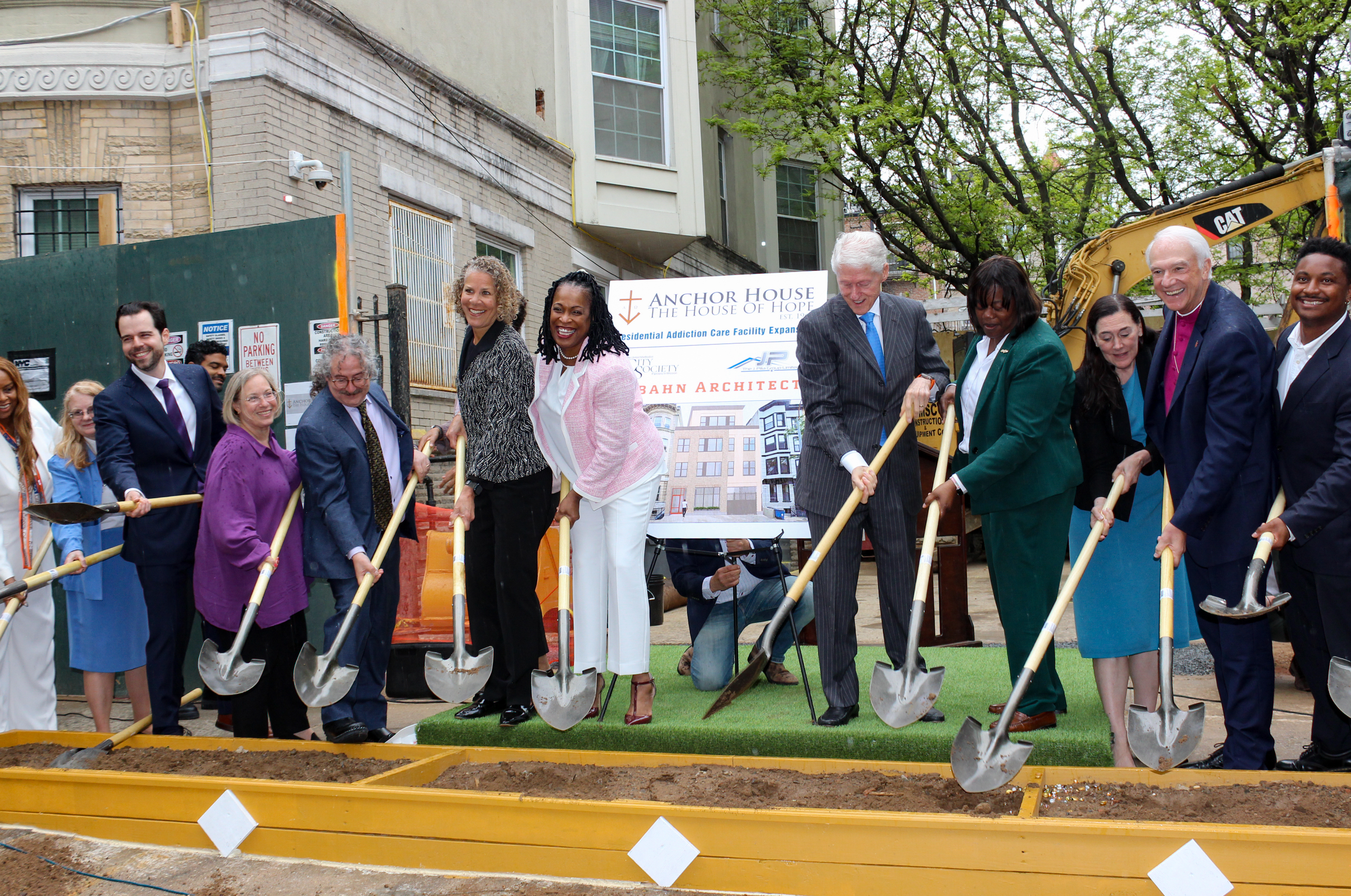 group of people with shovels for a ceremonial ground breaking