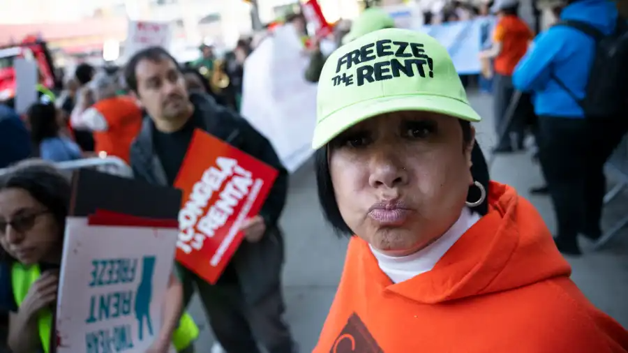 person with freeze the rent hat