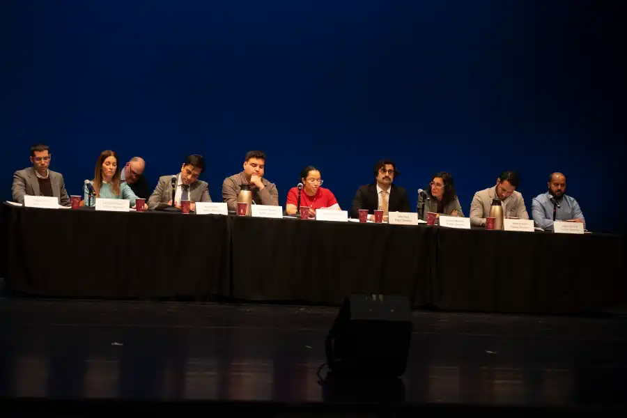 people at a table on a stage